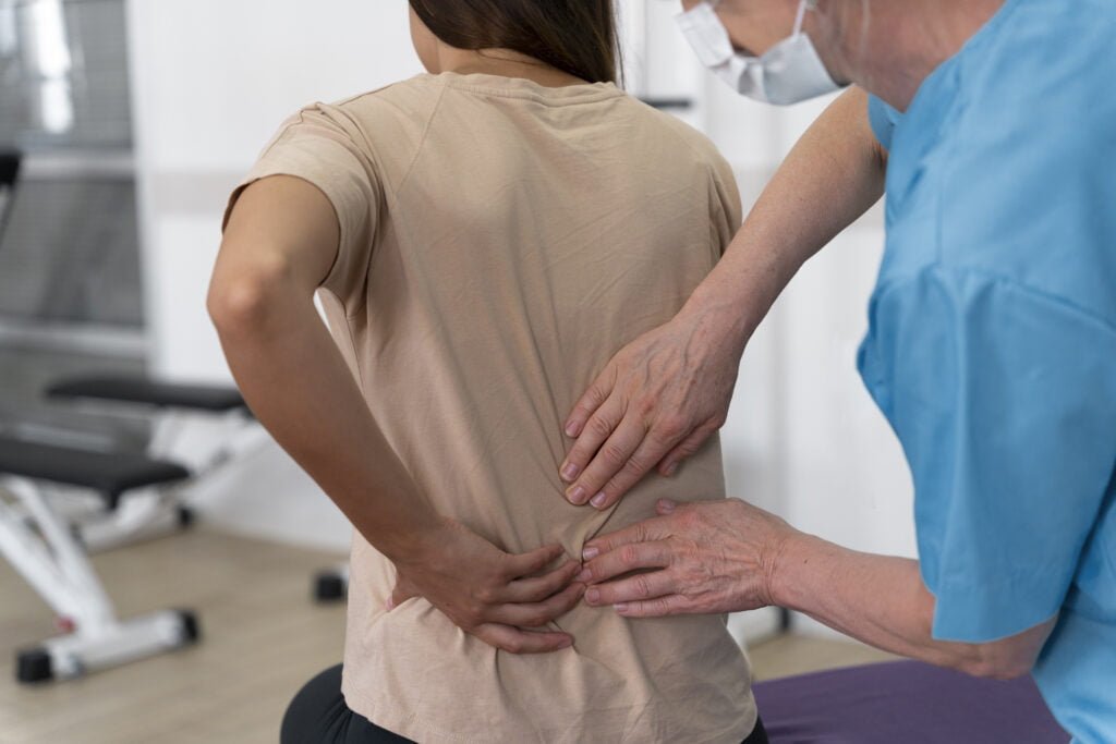 medical assistant helping patient with physiotherapy exercises 1
