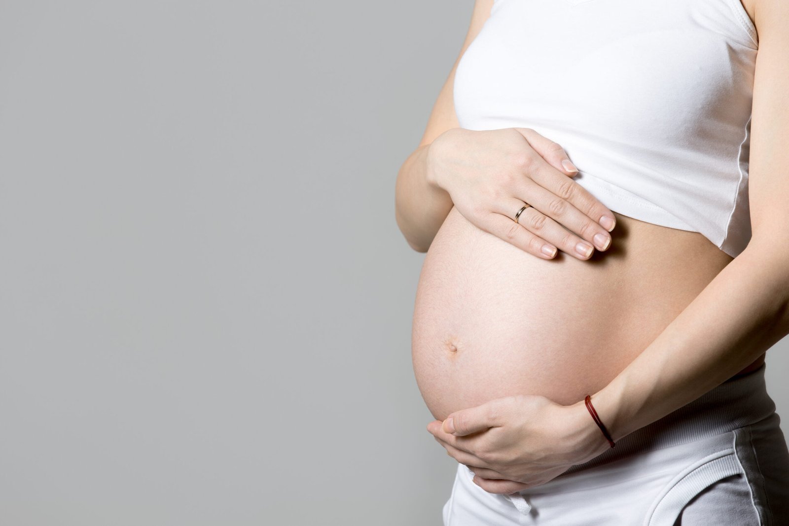 Chiropractic for pregnant mummies! 1 pregnant woman touching her belly scaled