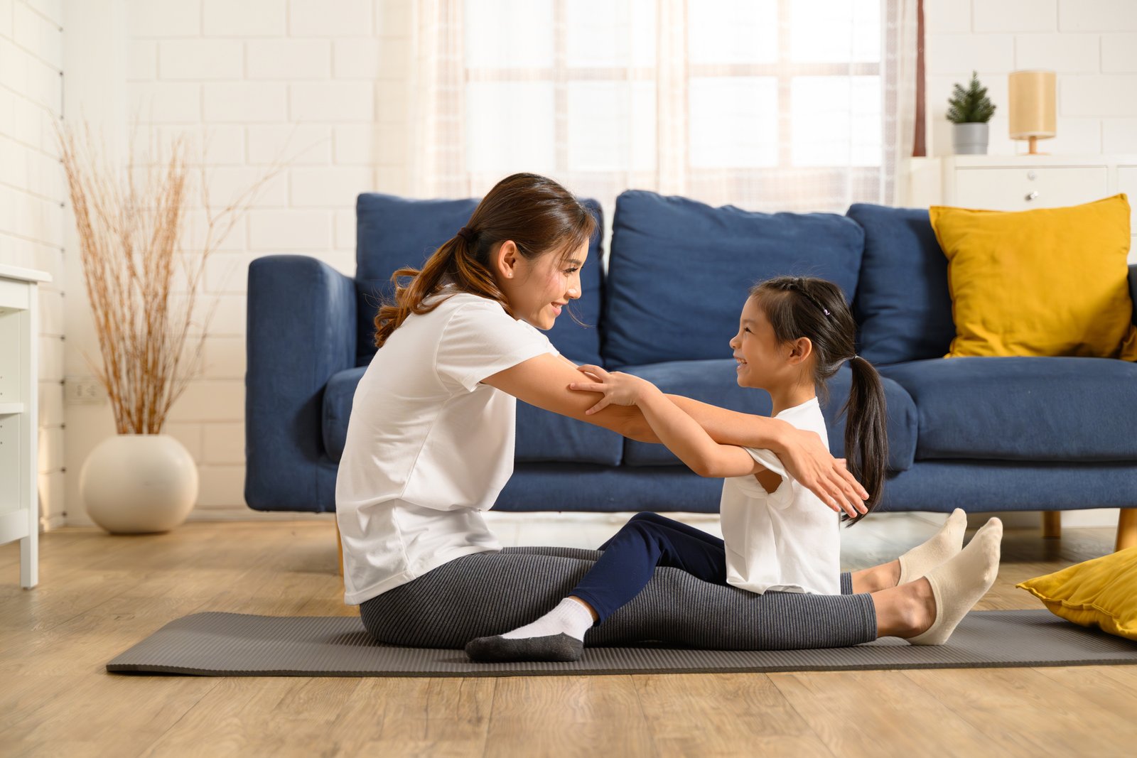 family home exercise and yoga. Yoga and exercise at living room. pediatric chiropractor