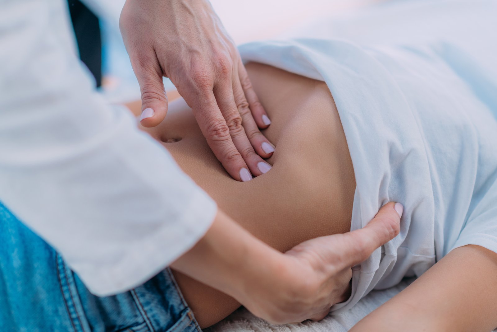 Pediatric Gastroenterology, Abdominal Examination. Pediatrician gastroenterologist, medical doctor who specializes in the diagnosis and treatment of gastrointestinal tract disorders doing abdominal examination to a preschooler boy